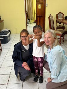 Volunteers helping a child receive hearing care