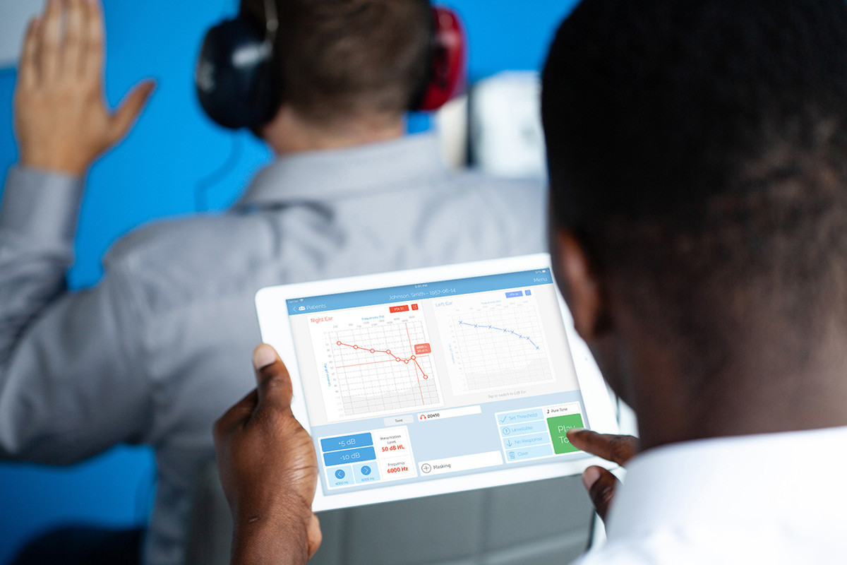 SHOEBOX Audiogram Review - Man performing audiological testing using SHOEBOX