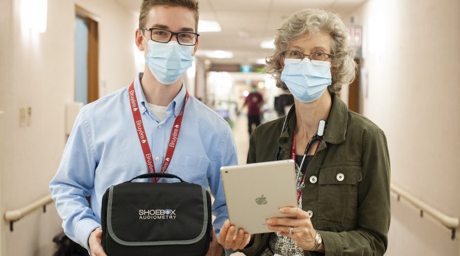 Image of Bruyere staff holding SHOEBOX QuickTest for in-patient hearing screening