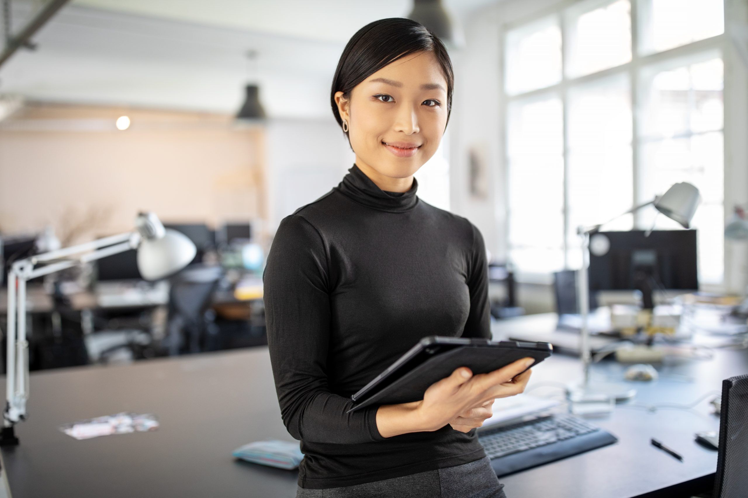 A photo of a young woman working on a tablet