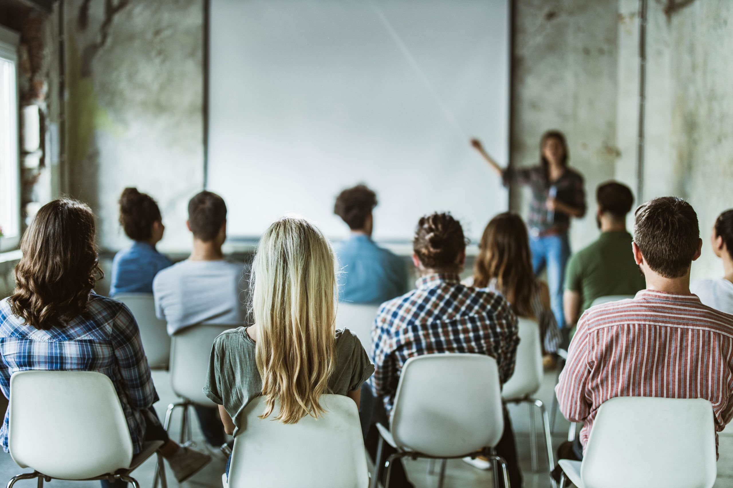 A photo of a group of people learning in a training session