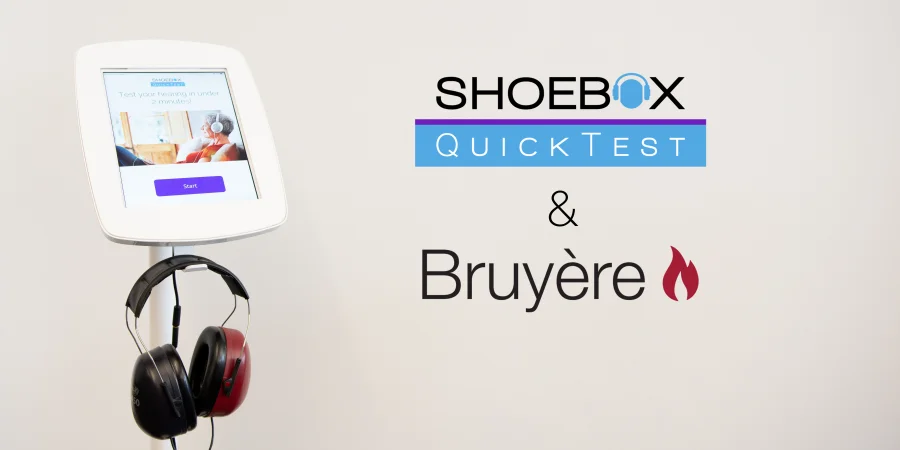 An image of SHOEBOX QuickTest in a kiosk stand with headphones