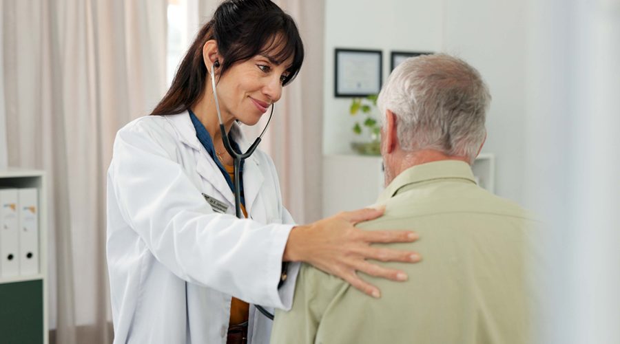 Woman, doctor and heart beat with senior patient for healthcare checkup or visit in hospital. Female person, health worker or cardiologist listening with stethoscope for elderly client or examinatio